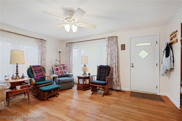 605 6th St, Barling, AR 72923 - living room with crown molding, a ceiling fan, baseboards, and light wood-style flooring