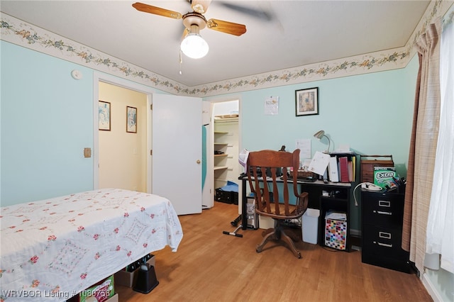 605 6th St, Barling, AR 72923 - bedroom featuring ceiling fan, a spacious closet, wood finished floors, and a closet