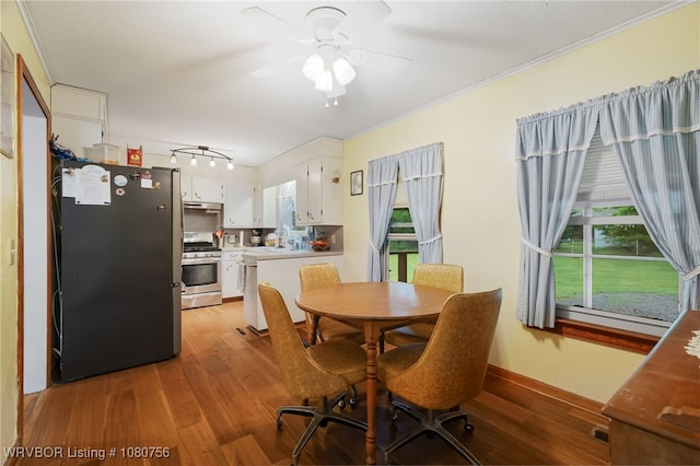 605 6th St, Barling, AR 72923 - dining space with plenty of natural light, ornamental molding, a ceiling fan, and wood finished floors