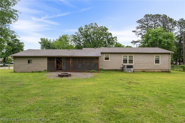 605 6th St, Barling, AR 72923 - back of house with a sunroom, a fire pit, and a lawn