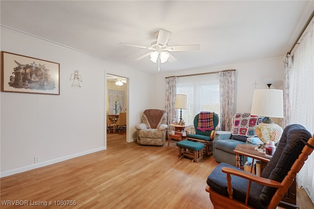 605 6th St, Barling, AR 72923 - living room featuring light wood-style floors, baseboards, and a ceiling fan