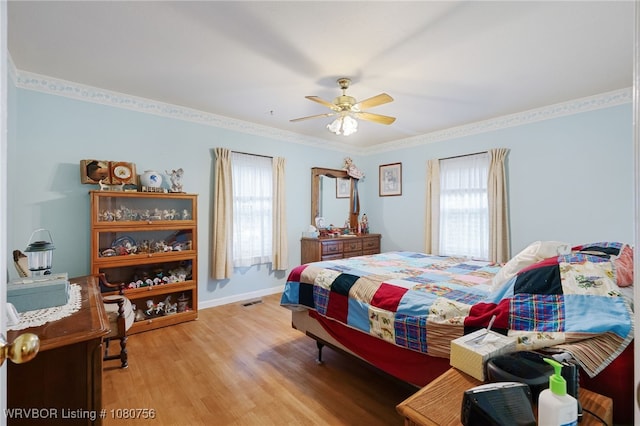 605 6th St, Barling, AR 72923 - bedroom featuring ceiling fan, baseboards, multiple windows, and light wood-style flooring