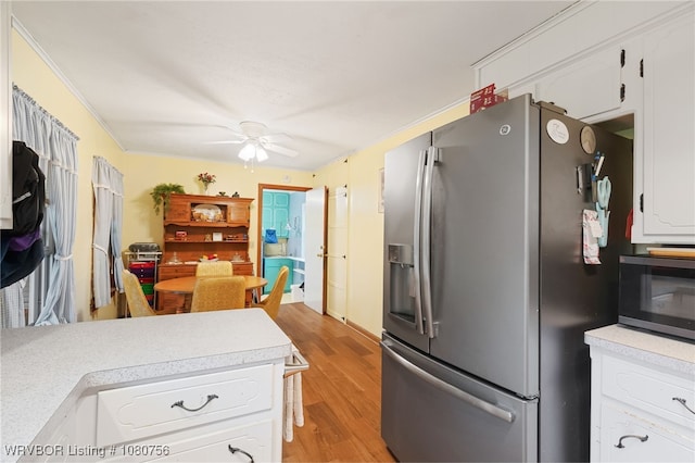605 6th St, Barling, AR 72923 - kitchen with light countertops, stainless steel appliances, light wood-type flooring, and white cabinetry