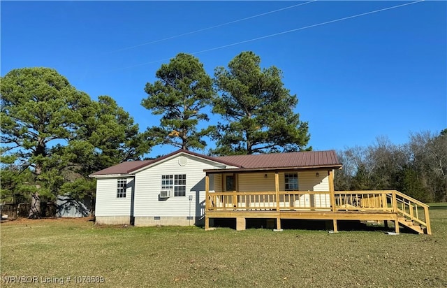 rear view of house with a yard and a deck