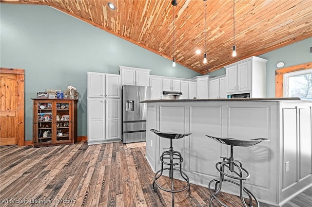 kitchen featuring stainless steel refrigerator with ice dispenser, wooden ceiling, white cabinetry, and pendant lighting