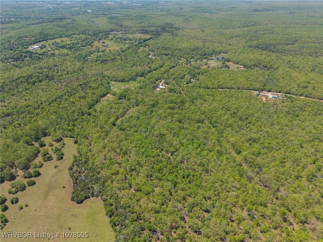 drone / aerial view featuring a wooded view