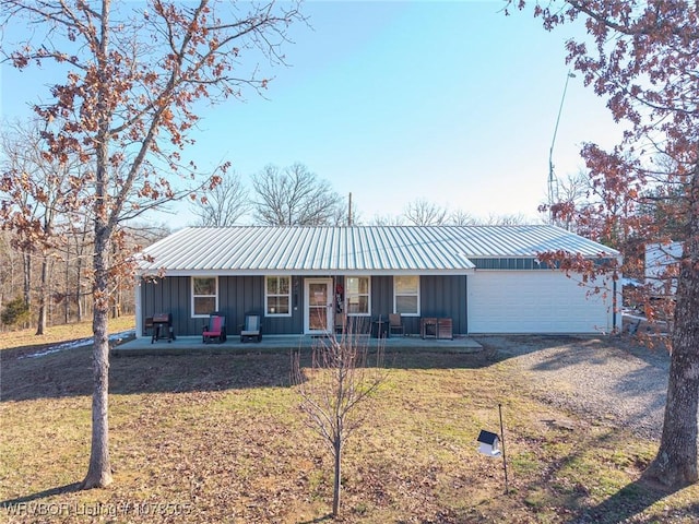 ranch-style house with a porch, a garage, and a front lawn