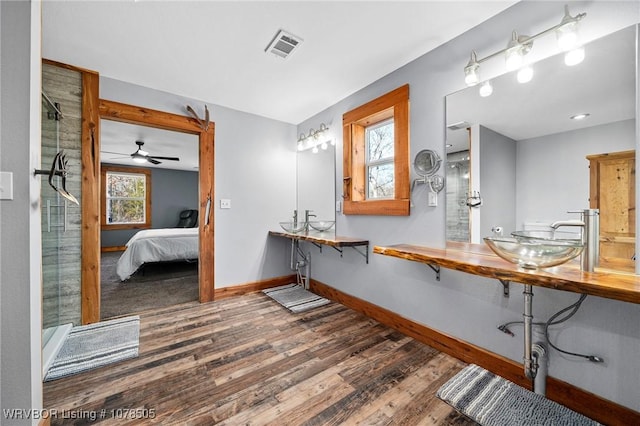 bathroom featuring a shower, sink, and wood-type flooring