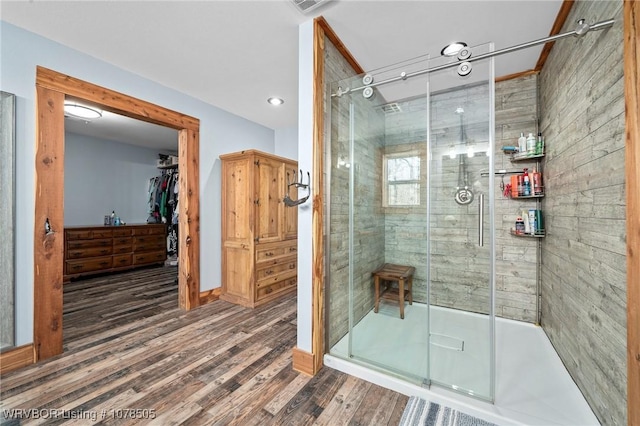 bathroom with hardwood / wood-style floors and a shower with door