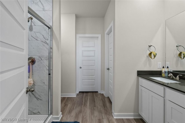 3912 Kent Ln, Springdale, AR 72764 - bathroom with a stall shower, vanity, baseboards, and wood finished floors