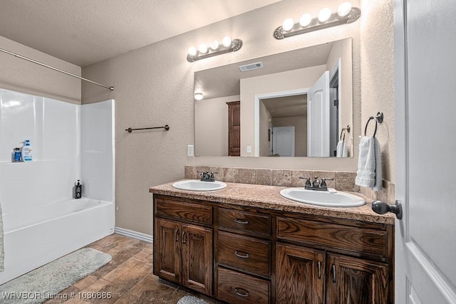 1917 Fisher Rd, Muldrow, OK 74948 - full bath with a textured wall, double vanity, bathing tub / shower combination, baseboards, and a textured ceiling