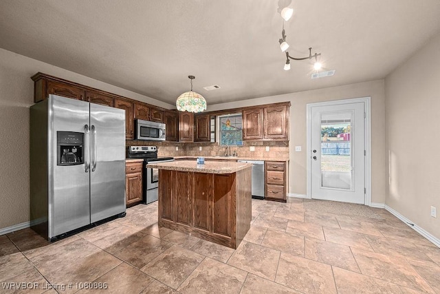 1917 Fisher Rd, Muldrow, OK 74948 - kitchen featuring stainless steel appliances, a sink, baseboards, and tasteful backsplash