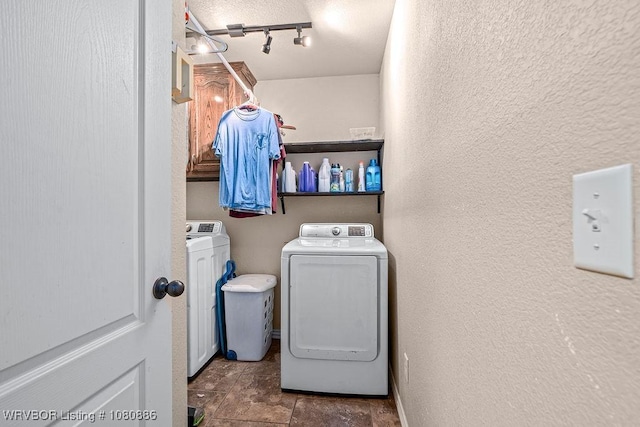 1917 Fisher Rd, Muldrow, OK 74948 - clothes washing area with washer and dryer, a textured wall, cabinet space, rail lighting, and stone finish floors