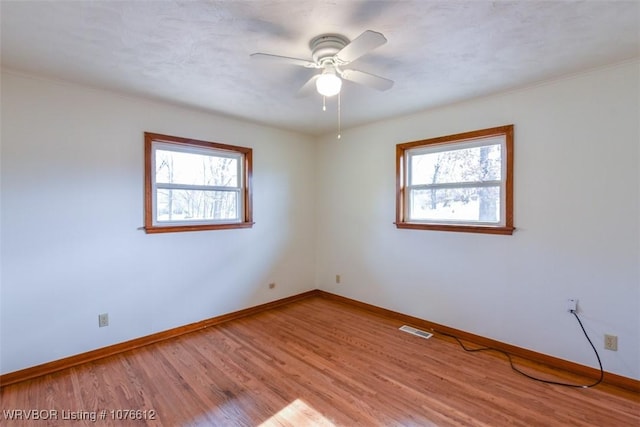 unfurnished room with light hardwood / wood-style floors, ceiling fan, and ornamental molding