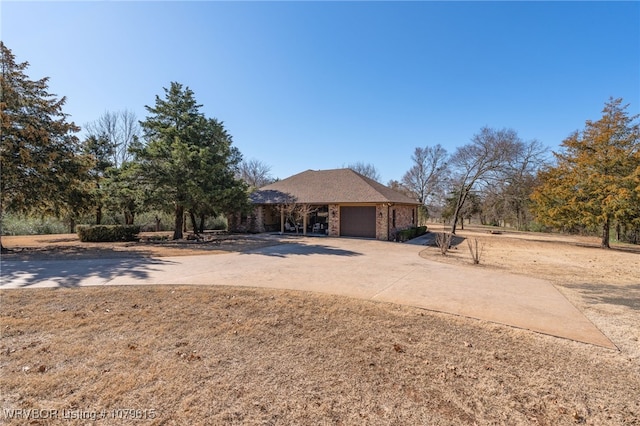 ranch-style house featuring concrete driveway and a garage