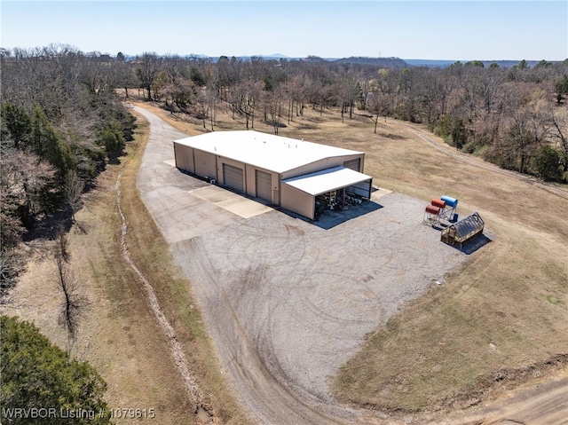 drone / aerial view featuring a rural view and a view of trees