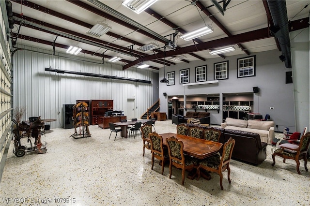 dining area featuring metal wall and speckled floor