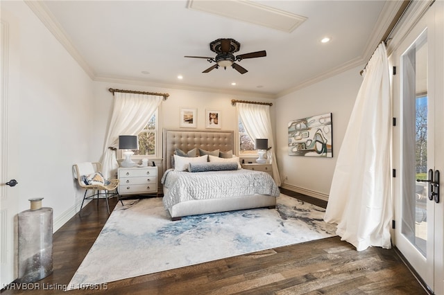 bedroom featuring crown molding, baseboards, and wood finished floors