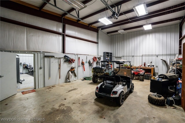 garage with a workshop area and metal wall