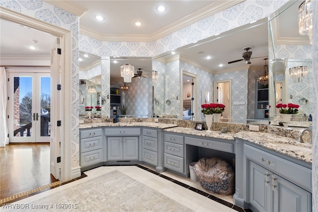 bathroom featuring wallpapered walls, ornamental molding, recessed lighting, ceiling fan with notable chandelier, and vanity