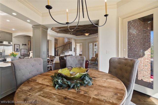 dining room with dark wood finished floors, recessed lighting, arched walkways, crown molding, and stairs