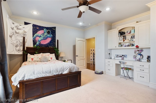 carpeted bedroom with a ceiling fan, visible vents, recessed lighting, built in desk, and crown molding