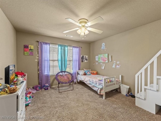 1112 Persimmon St, Greenwood, AR 72936 - bedroom with carpet flooring, a textured ceiling, and a ceiling fan
