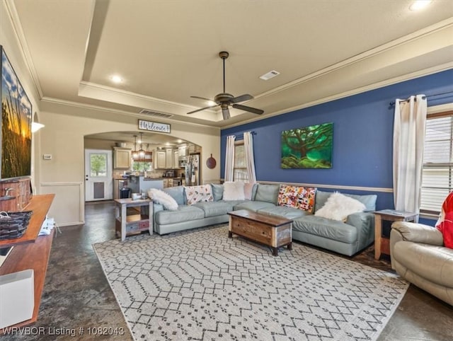 1112 Persimmon St, Greenwood, AR 72936 - living area featuring arched walkways, a raised ceiling, crown molding, ceiling fan, and recessed lighting