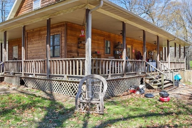 view of side of home featuring covered porch