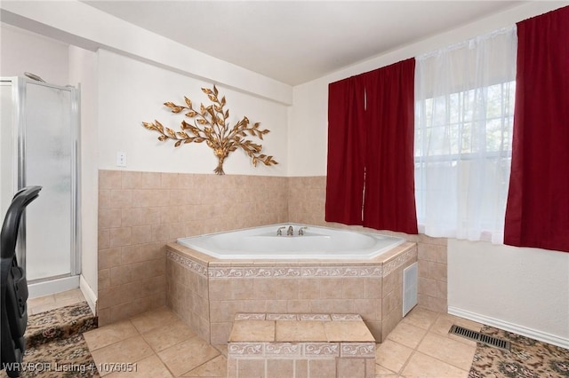 bathroom with tile patterned floors and separate shower and tub