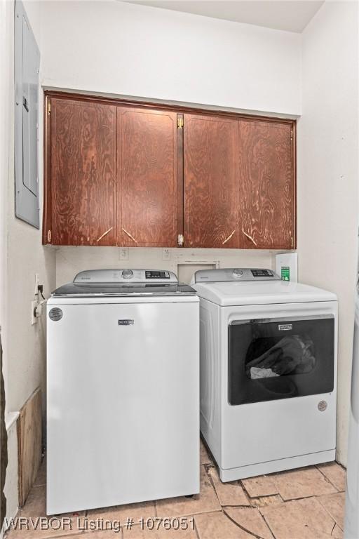 laundry room with cabinets, electric panel, and separate washer and dryer