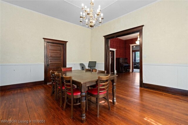 dining area featuring a chandelier and dark hardwood / wood-style flooring