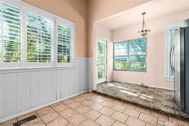 interior space with light tile patterned floors and a wealth of natural light