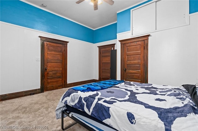 bedroom featuring carpet, ceiling fan, crown molding, and a closet