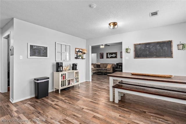 interior space featuring a textured ceiling and hardwood / wood-style flooring