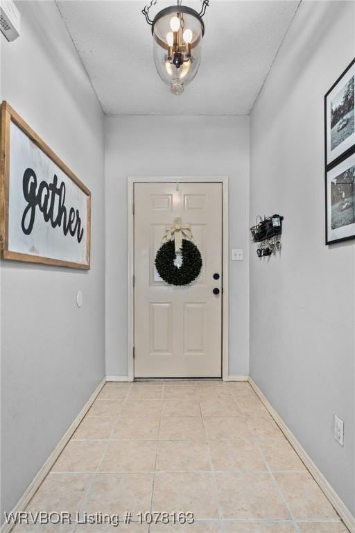 doorway with light tile patterned flooring