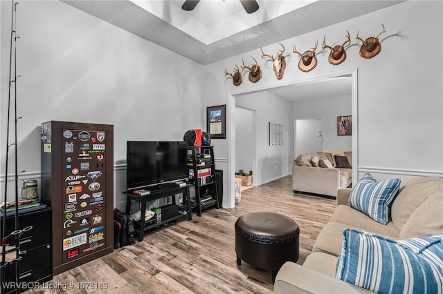 living room featuring ceiling fan and wood-type flooring