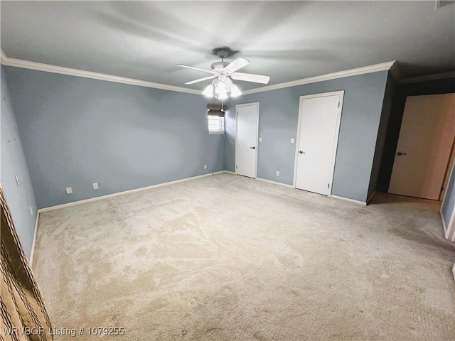 unfurnished bedroom featuring two closets, carpet, baseboards, and crown molding