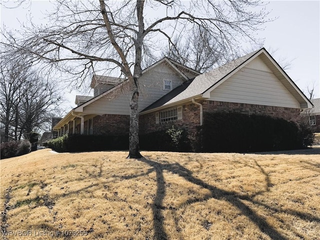 view of side of home with brick siding