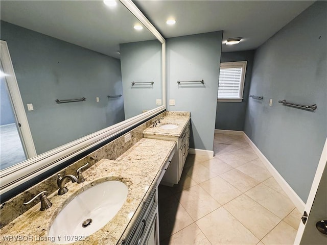 bathroom featuring tile patterned flooring, baseboards, and vanity