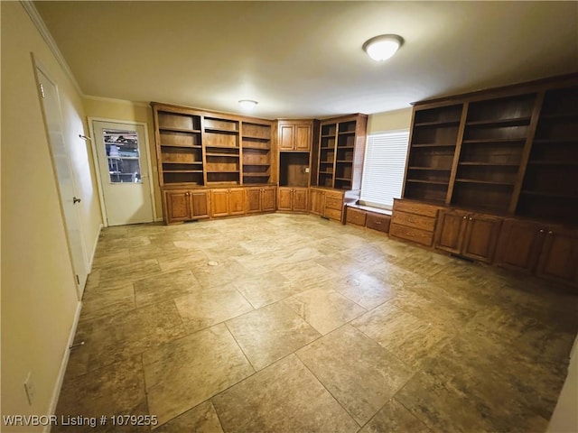 unfurnished office featuring crown molding and baseboards