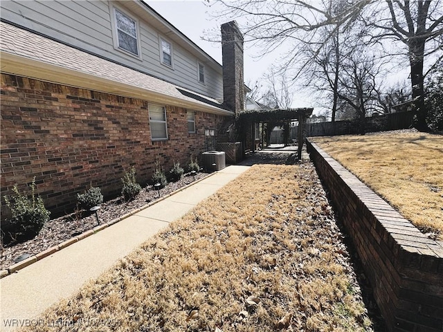 view of yard with fence and central air condition unit