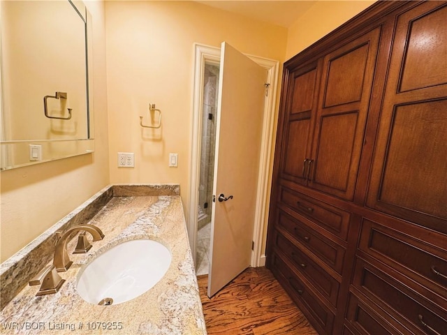 full bathroom featuring walk in shower and vanity