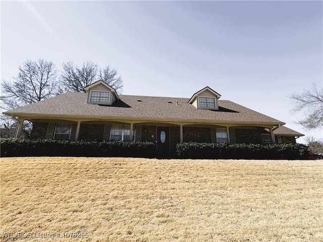 view of front of house featuring brick siding and a shingled roof