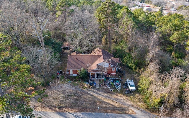 birds eye view of property featuring a view of trees