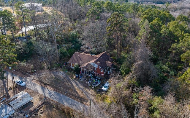 drone / aerial view featuring a view of trees