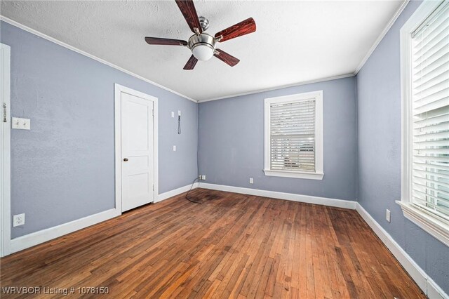 unfurnished bedroom featuring a textured ceiling, ceiling fan, crown molding, and dark hardwood / wood-style floors