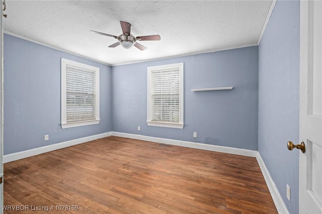 spare room featuring hardwood / wood-style floors, a textured ceiling, and crown molding