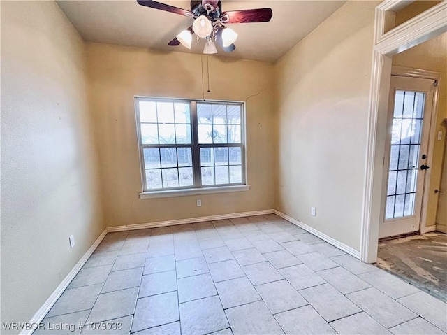 empty room featuring a wealth of natural light and ceiling fan