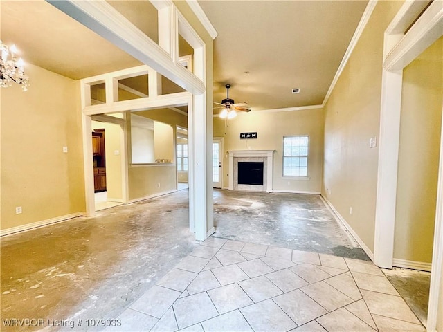 unfurnished living room featuring crown molding and ceiling fan with notable chandelier